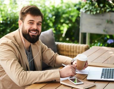 smiling-modern-businessman-working-in-cafe-2023-11-27-05-05-03-utc-Custom-2.jpg